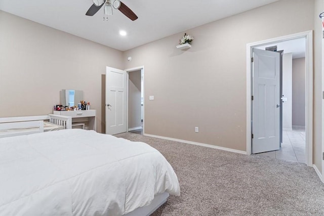 carpeted bedroom featuring baseboards and a ceiling fan