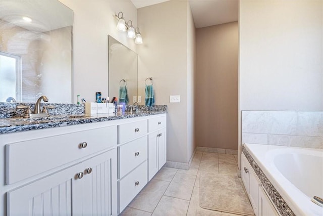 full bathroom featuring tile patterned floors, a sink, a bath, and double vanity