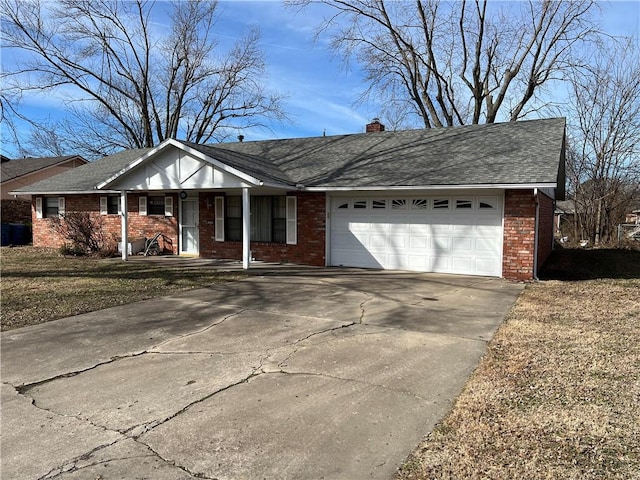 single story home featuring a garage, driveway, a shingled roof, a chimney, and brick siding