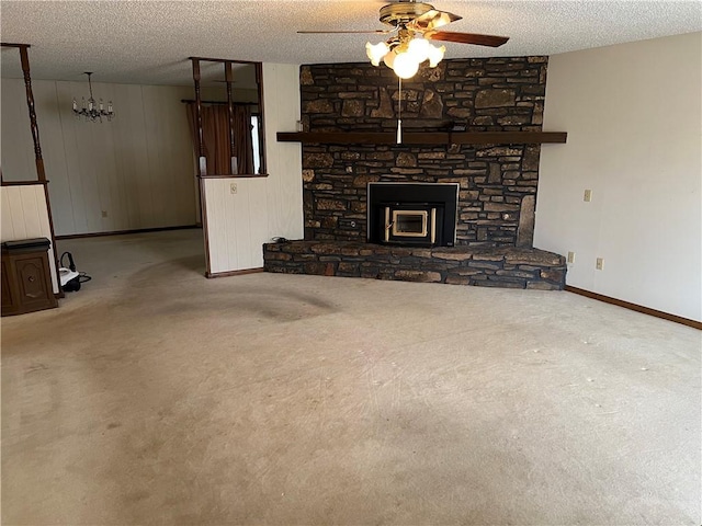 unfurnished living room with carpet floors, a textured ceiling, baseboards, and a ceiling fan