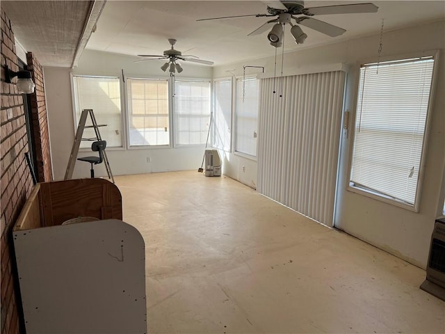 interior space with ceiling fan and concrete flooring