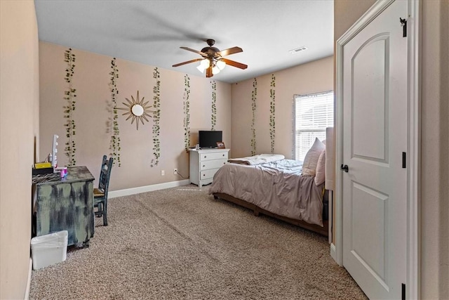 carpeted bedroom featuring ceiling fan, visible vents, and baseboards