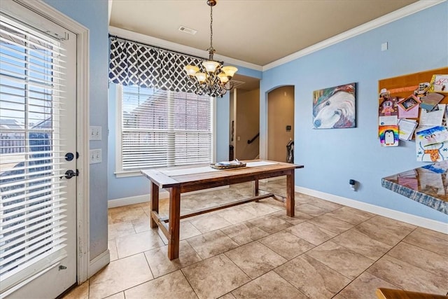 dining area with ornamental molding, arched walkways, baseboards, and an inviting chandelier