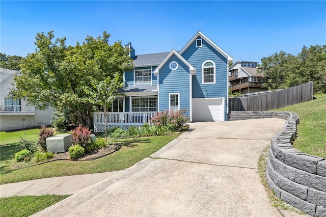 view of front of house with a chimney, a porch, an attached garage, fence, and driveway