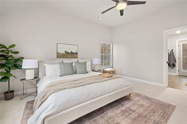 carpeted bedroom with lofted ceiling, a ceiling fan, visible vents, and baseboards