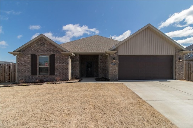 single story home with brick siding, board and batten siding, fence, a garage, and driveway