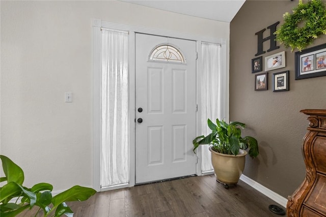 entryway with baseboards and wood finished floors