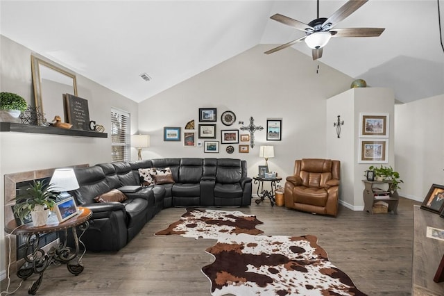 living room with baseboards, visible vents, a ceiling fan, wood finished floors, and a fireplace