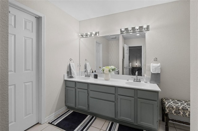 full bathroom featuring tile patterned flooring, a sink, and double vanity