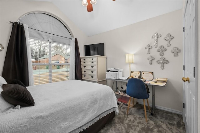 bedroom featuring lofted ceiling, baseboards, ceiling fan, and carpet