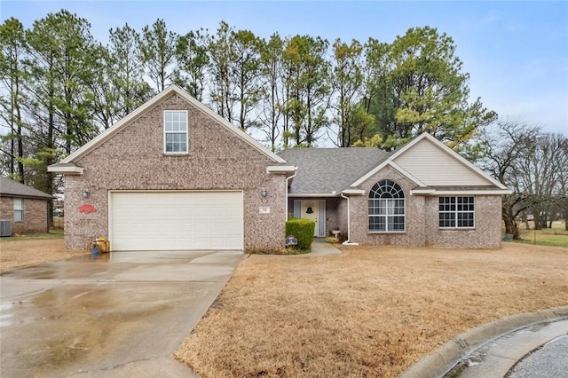 view of front facade with brick siding, a shingled roof, an attached garage, central AC, and driveway