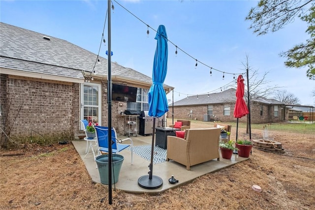 view of patio / terrace featuring an outdoor living space with a fire pit