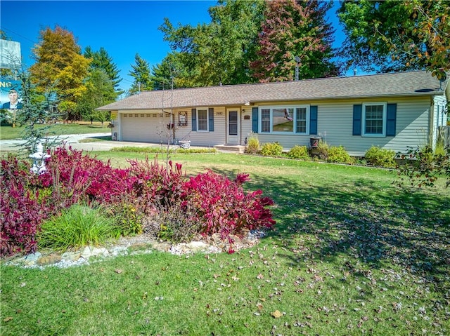 ranch-style home with an attached garage and a front lawn