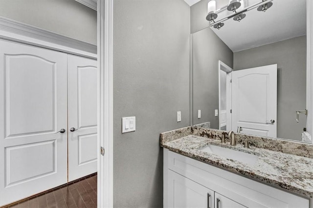 bathroom with vanity and wood finished floors