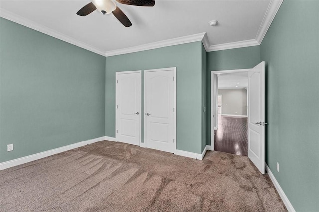 unfurnished bedroom featuring ceiling fan, carpet floors, ornamental molding, and baseboards