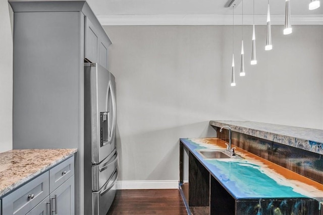 kitchen with dark wood-type flooring, a sink, ornamental molding, stainless steel refrigerator with ice dispenser, and gray cabinets