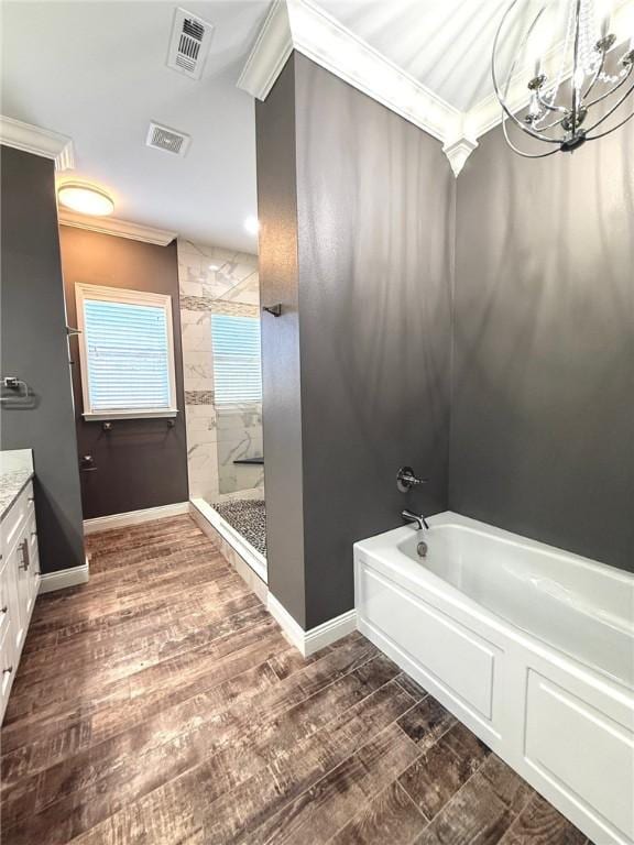 full bath with a garden tub, visible vents, a tile shower, vanity, and wood finished floors