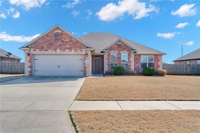 single story home with driveway, brick siding, an attached garage, and fence