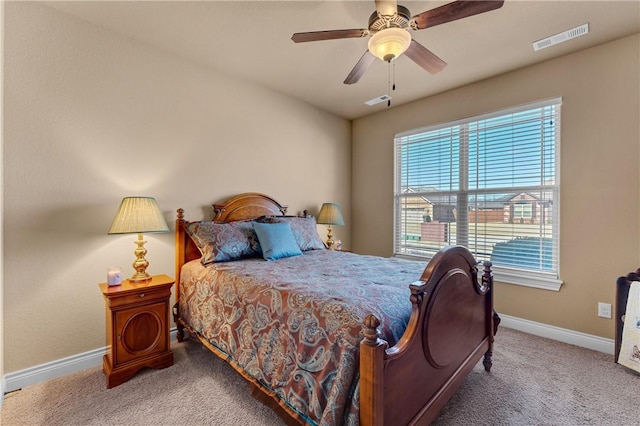 bedroom with carpet floors, visible vents, baseboards, and a ceiling fan