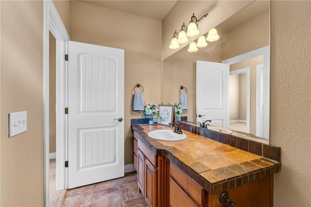 bathroom with vanity and baseboards