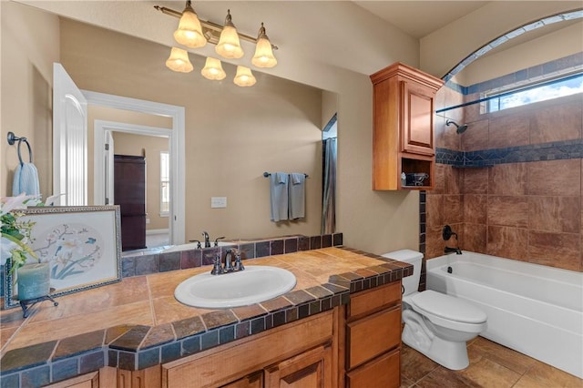 bathroom featuring toilet, tile patterned floors, shower / tub combination, and vanity