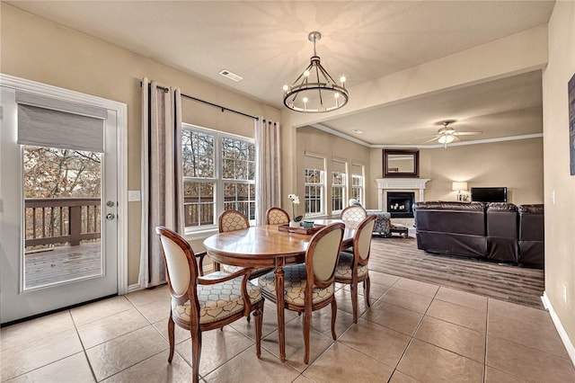 164 S Pinyon Pt, Fayetteville, AR 72701 - dining space with light tile patterned floors, a fireplace, a chandelier, baseboards, and ceiling fan