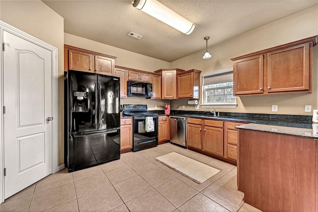 kitchen featuring visible vents, brown cabinetry, light tile patterned flooring, a textured ceiling, and black appliances