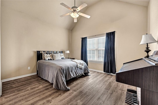bedroom featuring a ceiling fan, baseboards, wood finished floors, and high vaulted ceiling