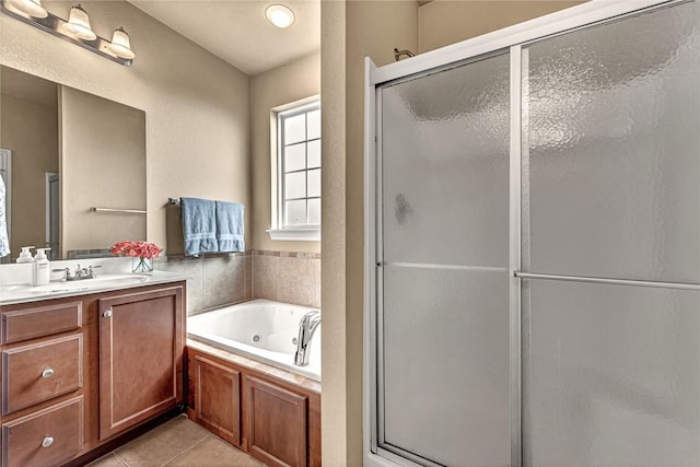 bathroom featuring vanity, a jetted tub, tile patterned floors, and a shower stall