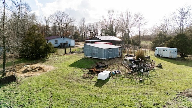 view of yard featuring an outdoor structure and fence