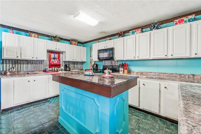 kitchen with a kitchen island, white cabinetry, black appliances, and a textured ceiling