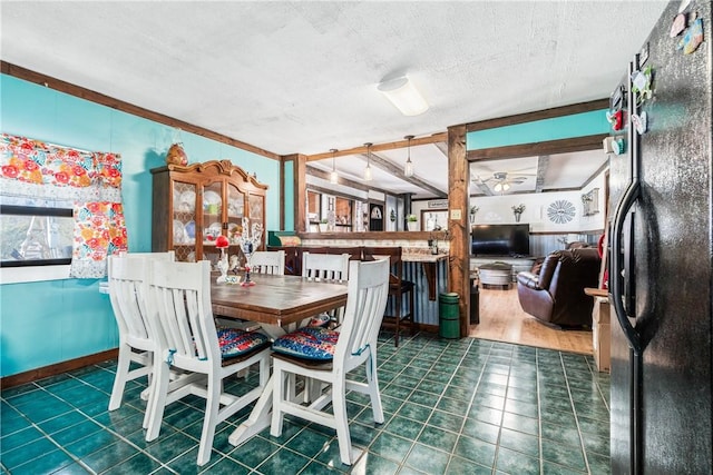 dining area featuring baseboards and a textured ceiling