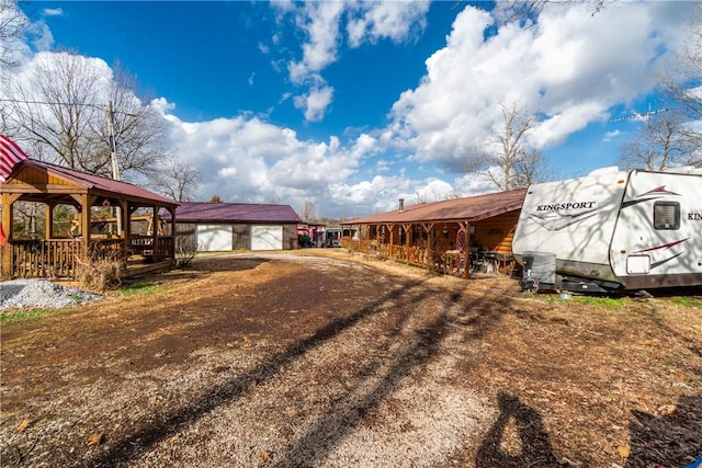 exterior space with a gazebo, a garage, and an outdoor structure