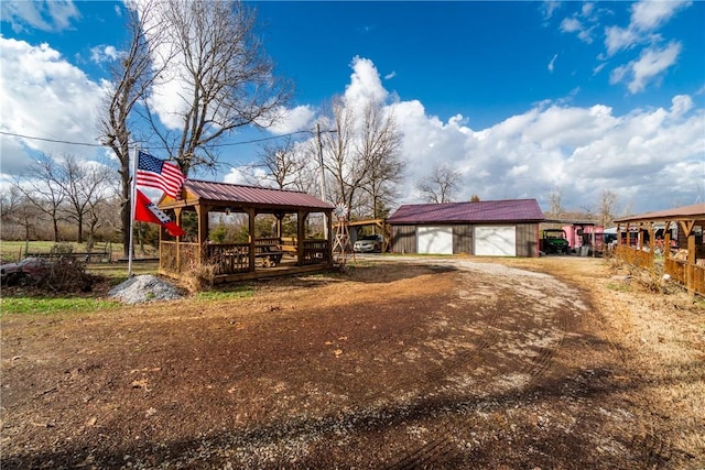 exterior space featuring a gazebo, an outdoor structure, and a garage