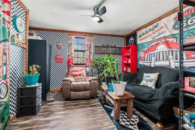 living area with a ceiling fan and wood finished floors