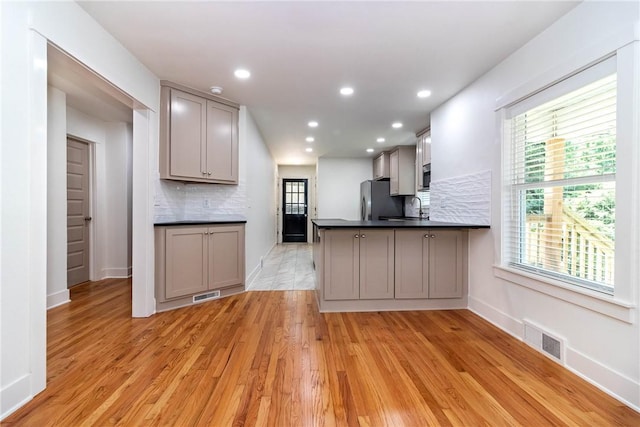 kitchen featuring dark countertops, gray cabinets, visible vents, and stainless steel appliances