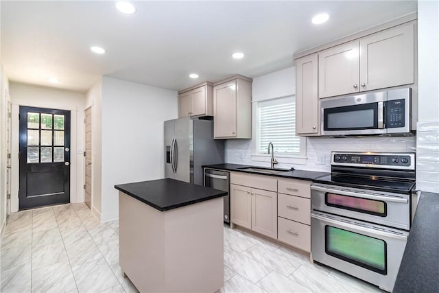 kitchen with appliances with stainless steel finishes, marble finish floor, a sink, and backsplash