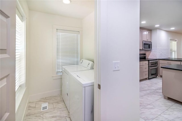 laundry area featuring marble finish floor, recessed lighting, visible vents, separate washer and dryer, and laundry area