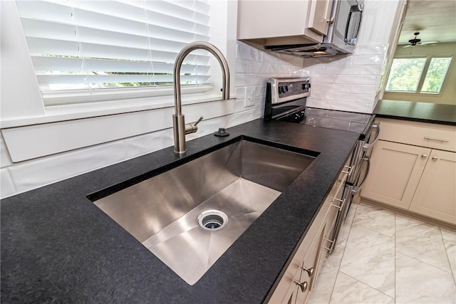 kitchen with electric stove, marble finish floor, decorative backsplash, a sink, and ceiling fan