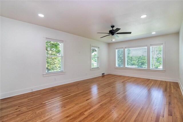 unfurnished room with light wood-type flooring, ceiling fan, baseboards, and recessed lighting