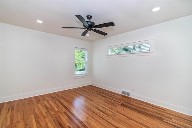 empty room featuring recessed lighting, a ceiling fan, light wood-style floors, visible vents, and baseboards