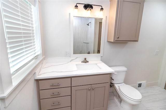 bathroom featuring toilet, marble finish floor, visible vents, and vanity