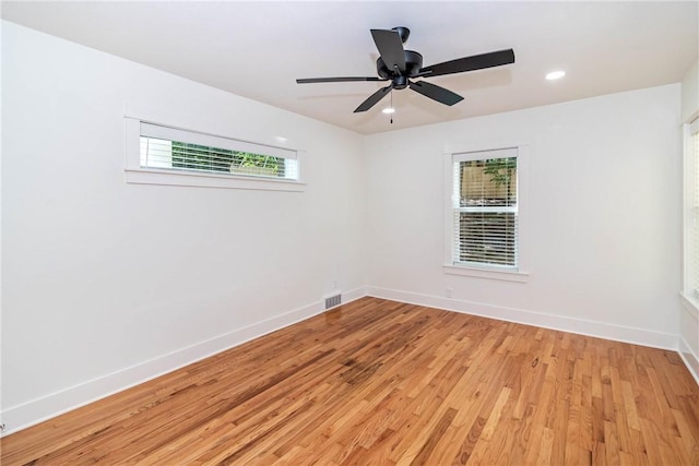 empty room with visible vents, baseboards, ceiling fan, light wood-style floors, and recessed lighting