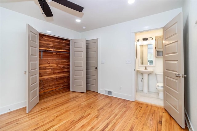 unfurnished bedroom with visible vents, ensuite bathroom, light wood-type flooring, a closet, and recessed lighting