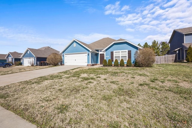 ranch-style home with a garage, driveway, a front yard, and fence