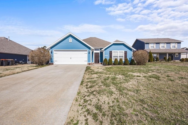 view of front of home featuring a front lawn, driveway, and an attached garage