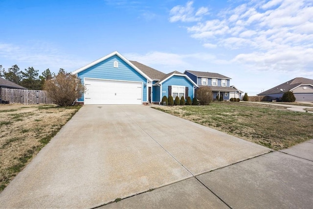 view of front of home with concrete driveway, a front lawn, an attached garage, and fence