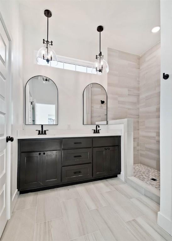 full bathroom featuring double vanity, walk in shower, and a sink