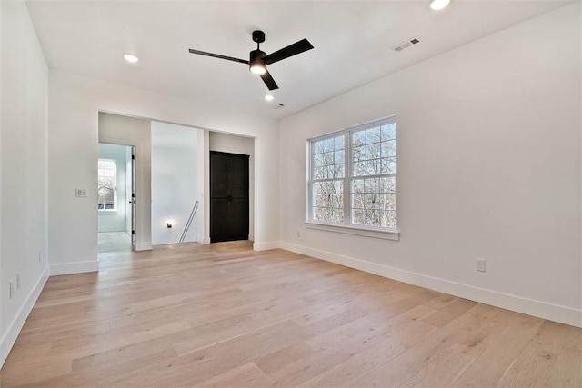 unfurnished bedroom featuring multiple windows, recessed lighting, visible vents, and light wood-style floors