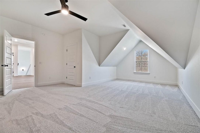 bonus room featuring baseboards, visible vents, lofted ceiling, ceiling fan, and carpet floors